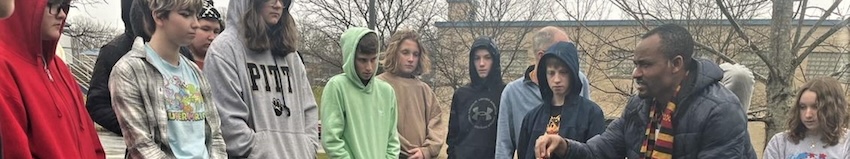 person teaching to students outside